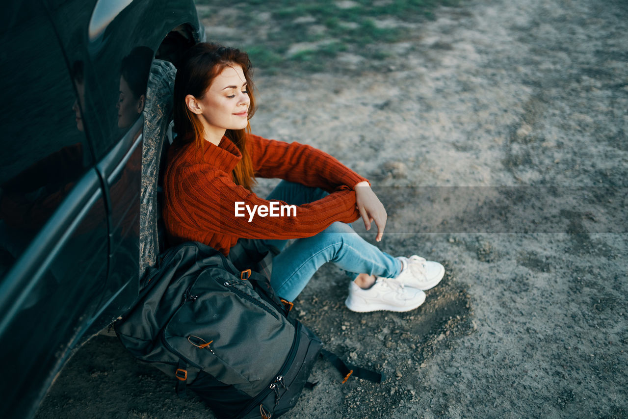 Portrait of smiling young woman sitting outdoors