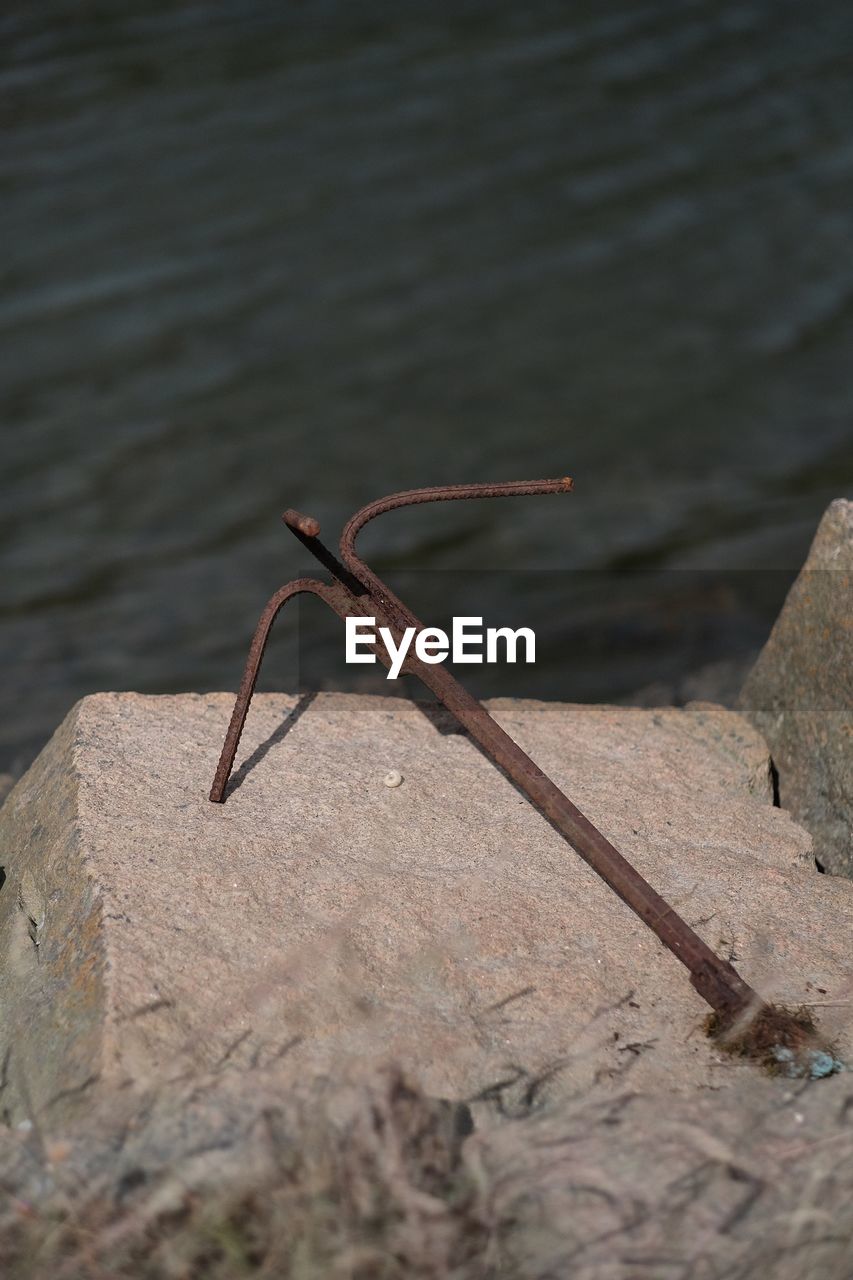 Close-up of anchor against the water