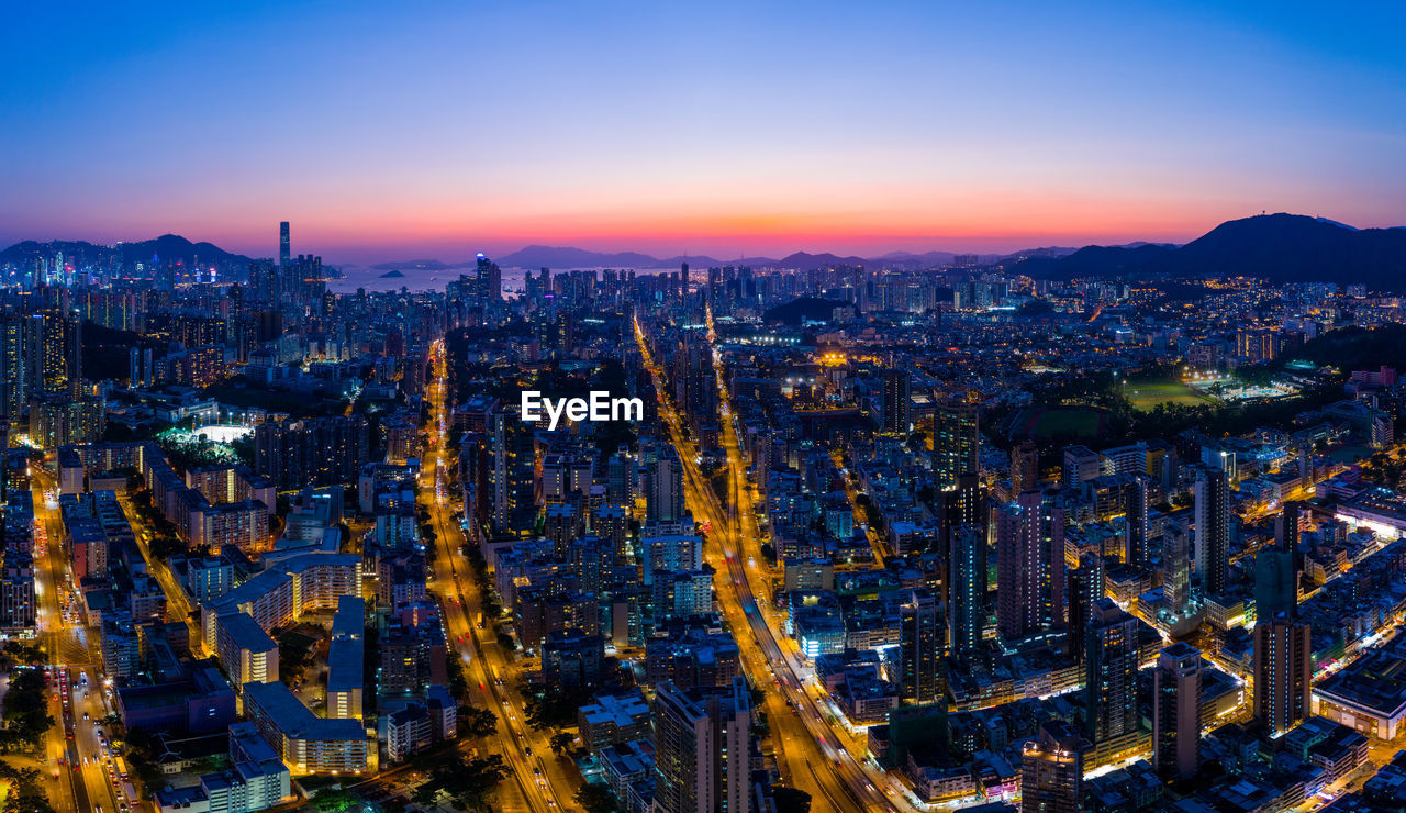 Aerial view of city against sky during sunset