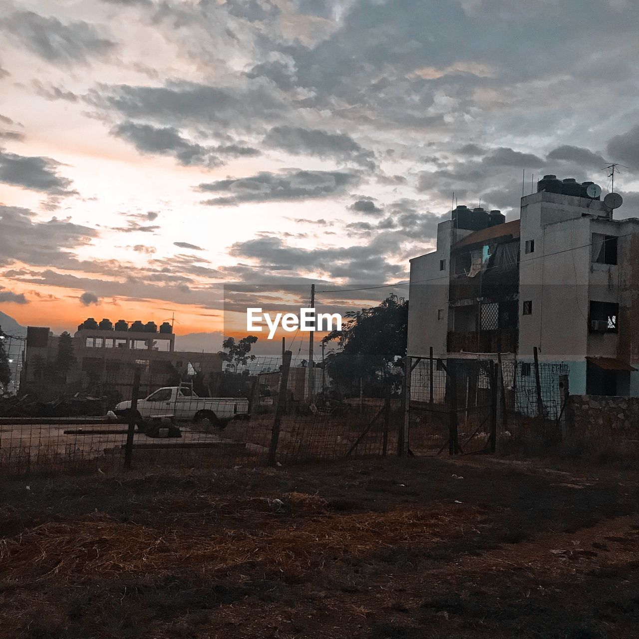 ABANDONED BUILDINGS AGAINST SKY DURING SUNSET