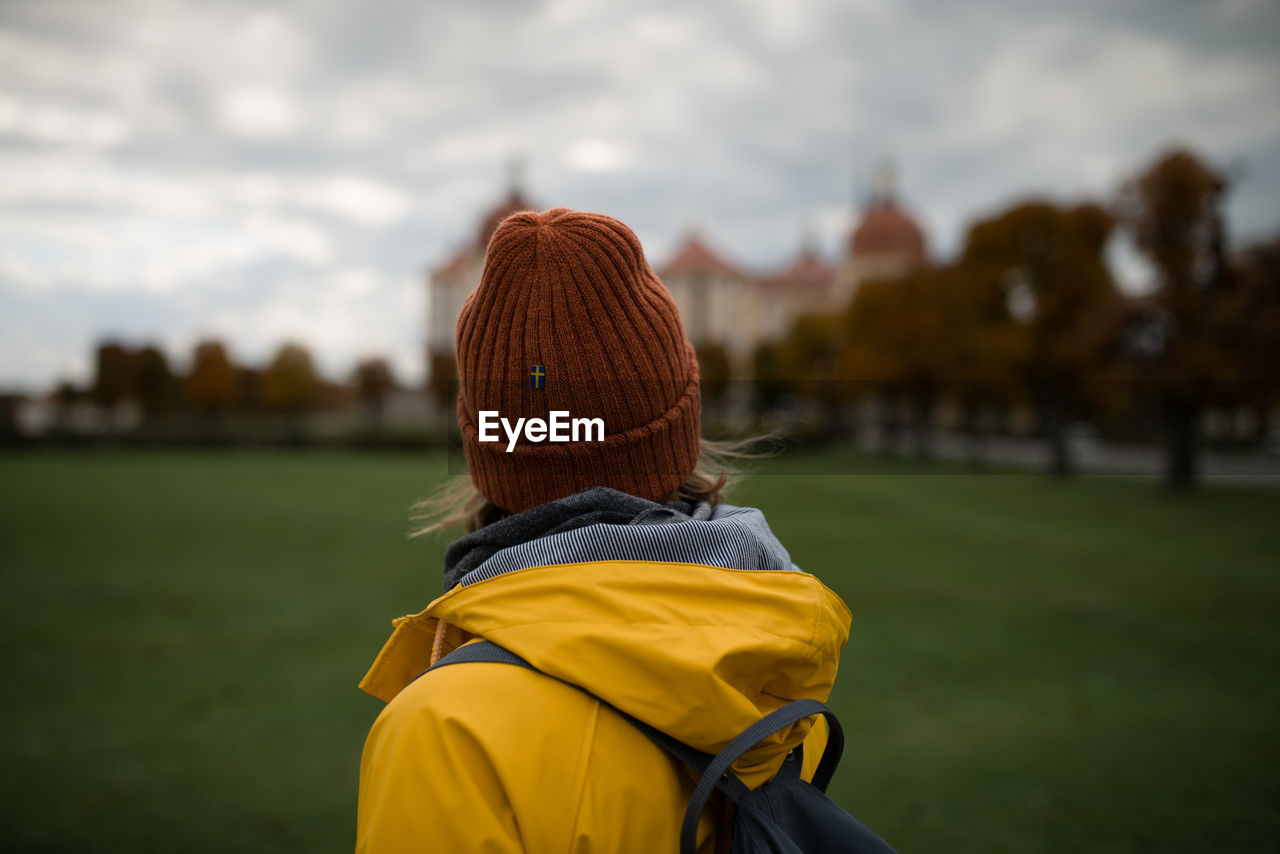 Rear view of person on soccer field against sky