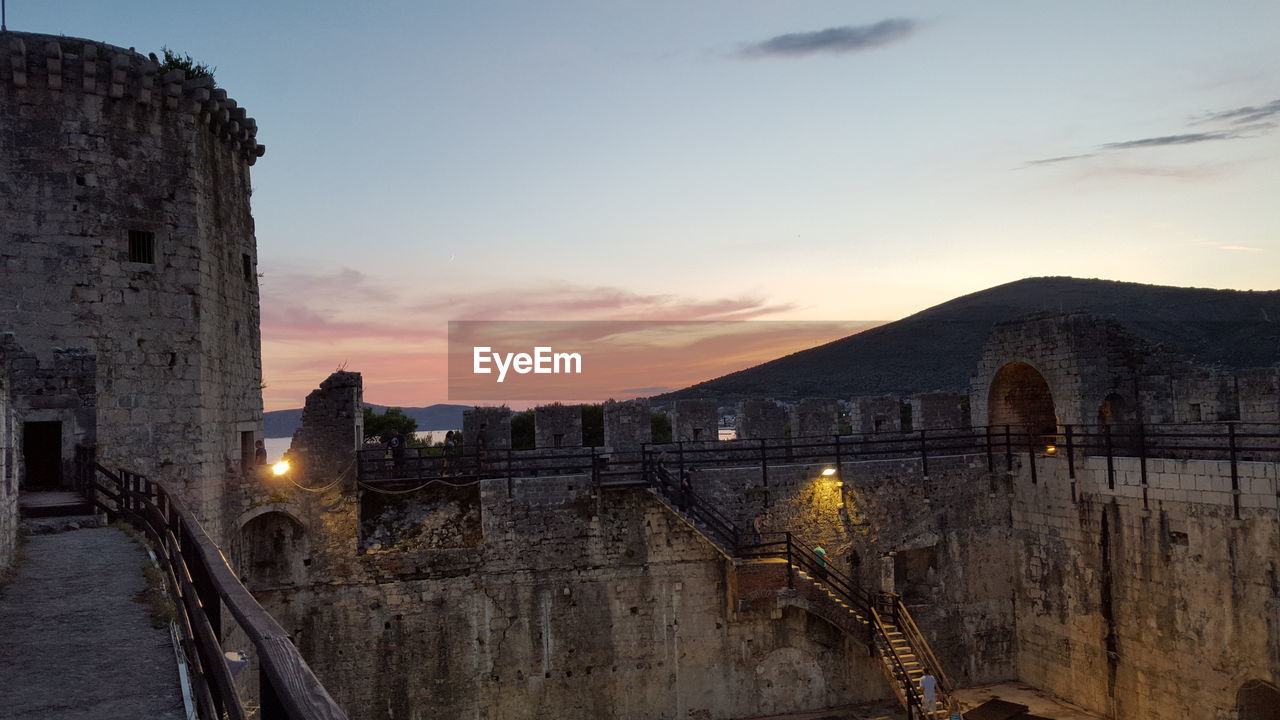 High angle view of historic building against sky during sunset