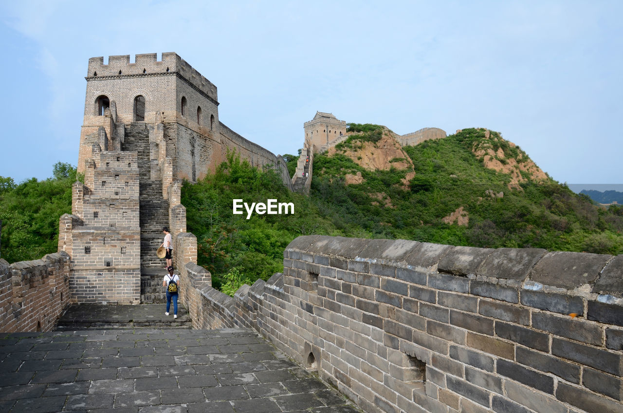 People at great wall of china against sky