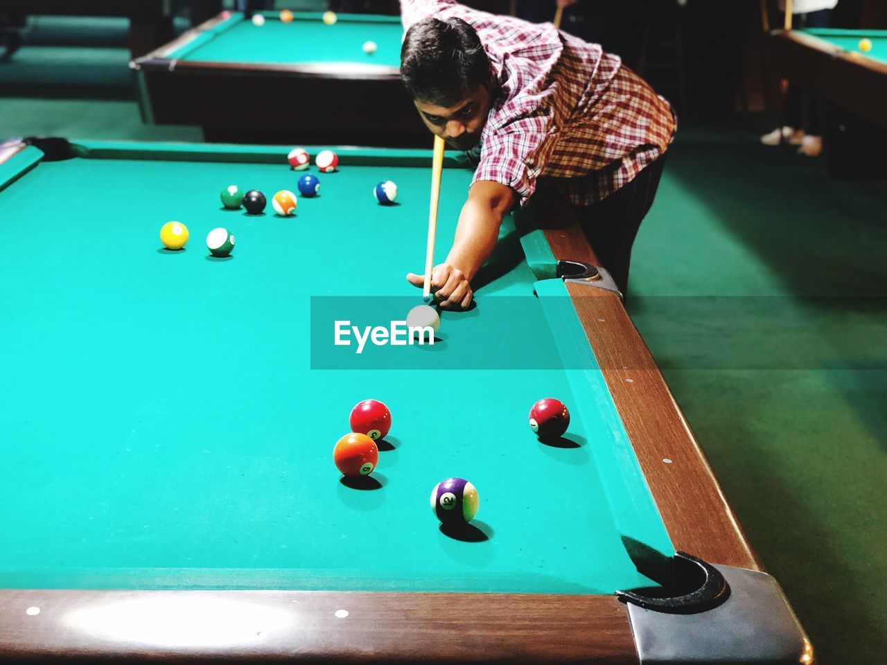 High angle view of young man playing pool ball