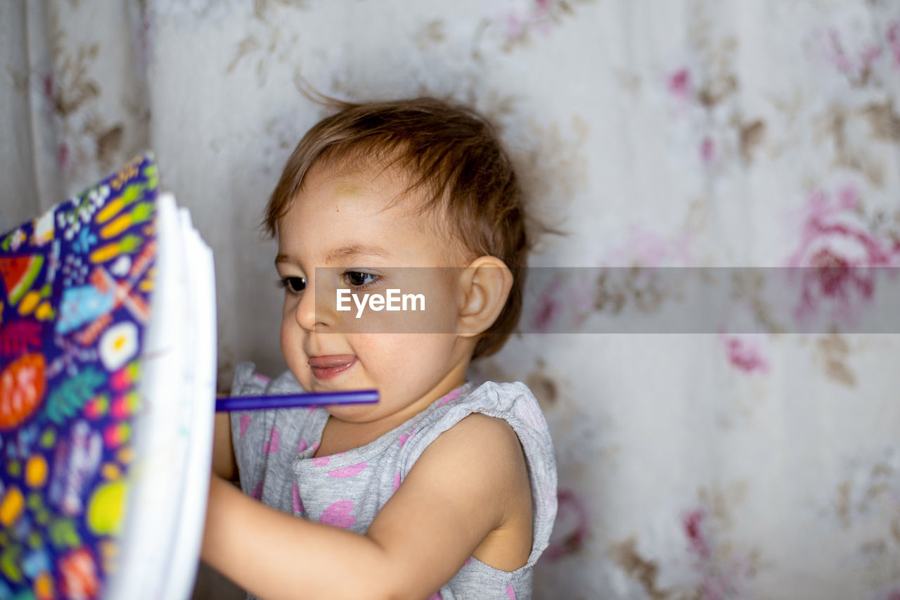 Portrait of cute baby girl at home