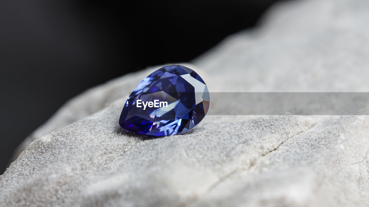 jewellery, gemstone, sapphire, fashion accessory, diamond, ring, jewelry, blue, luxury, wealth, precious gem, close-up, selective focus, no people, shiny, indoors, crystal, single object, purple