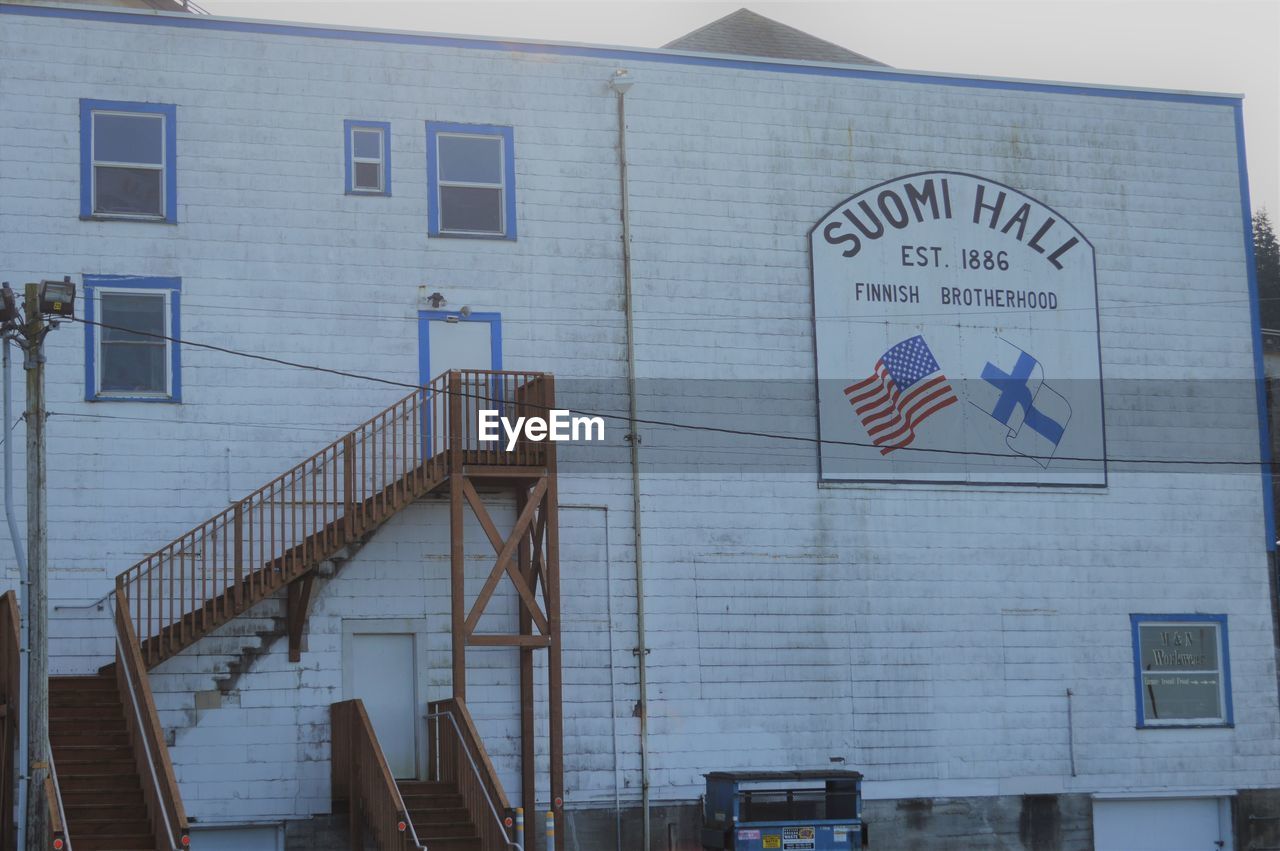 LOW ANGLE VIEW OF TEXT ON BUILDING WALL