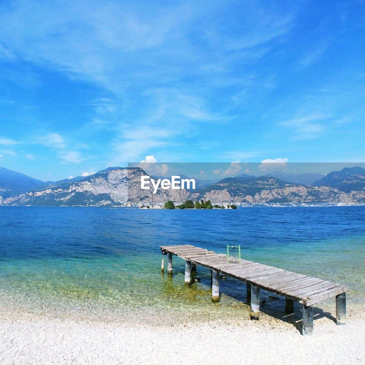 Scenic view of sea against blue sky / lake garda view / shades of blue / turquoise colour