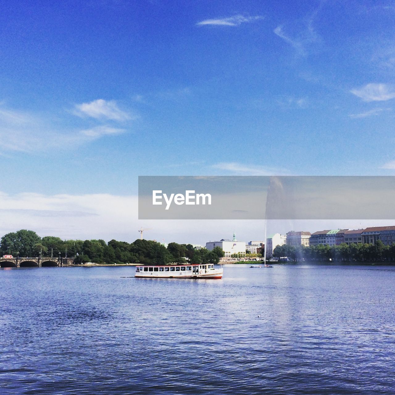 VIEW OF RIVER WITH BUILDINGS IN BACKGROUND