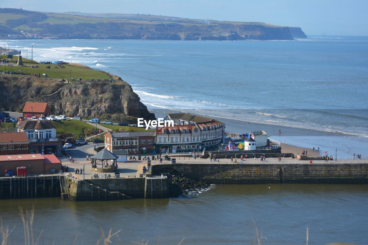 High angle view of sea and buildings against sky