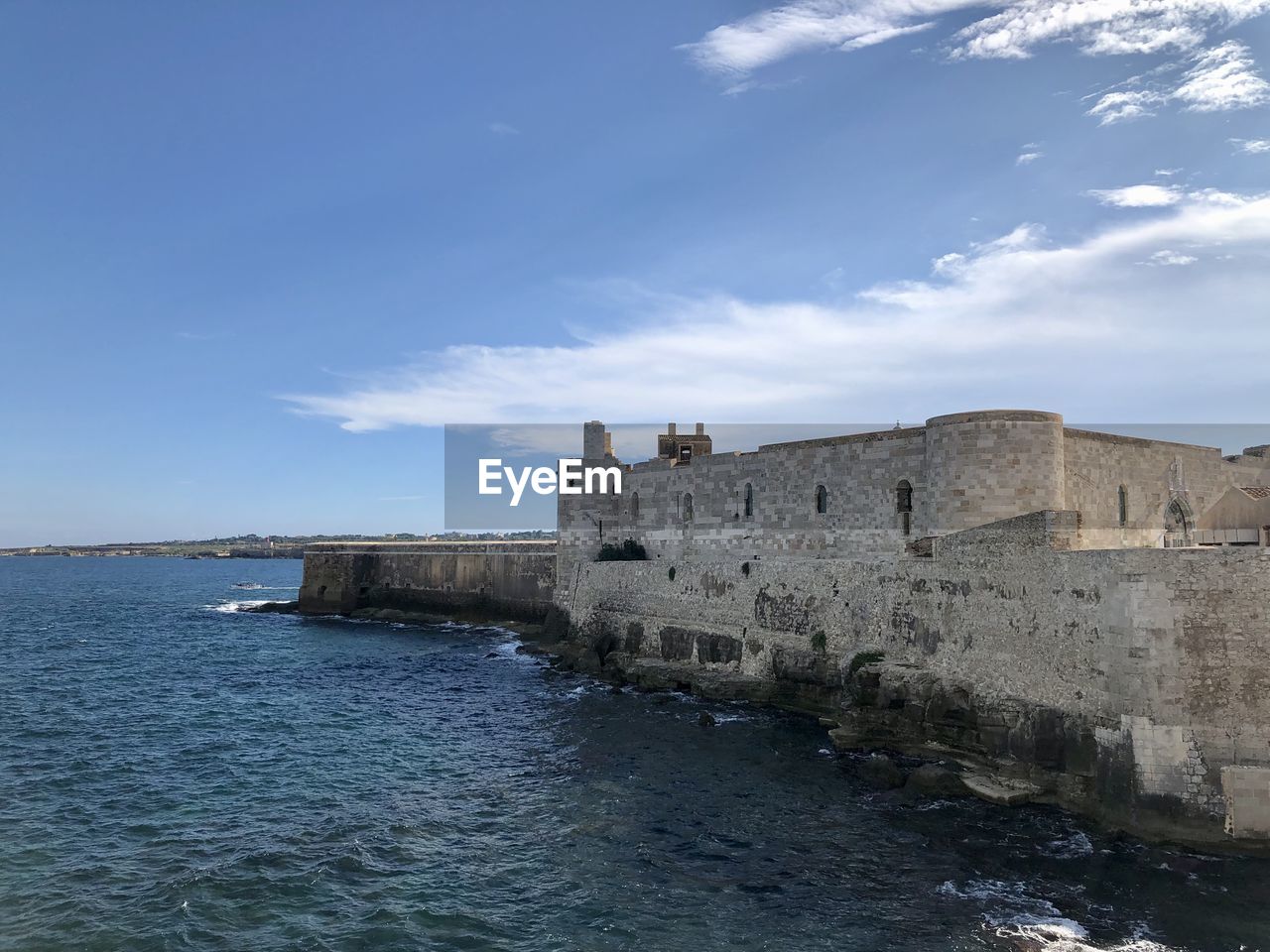 View of fort against blue sky, ortigia