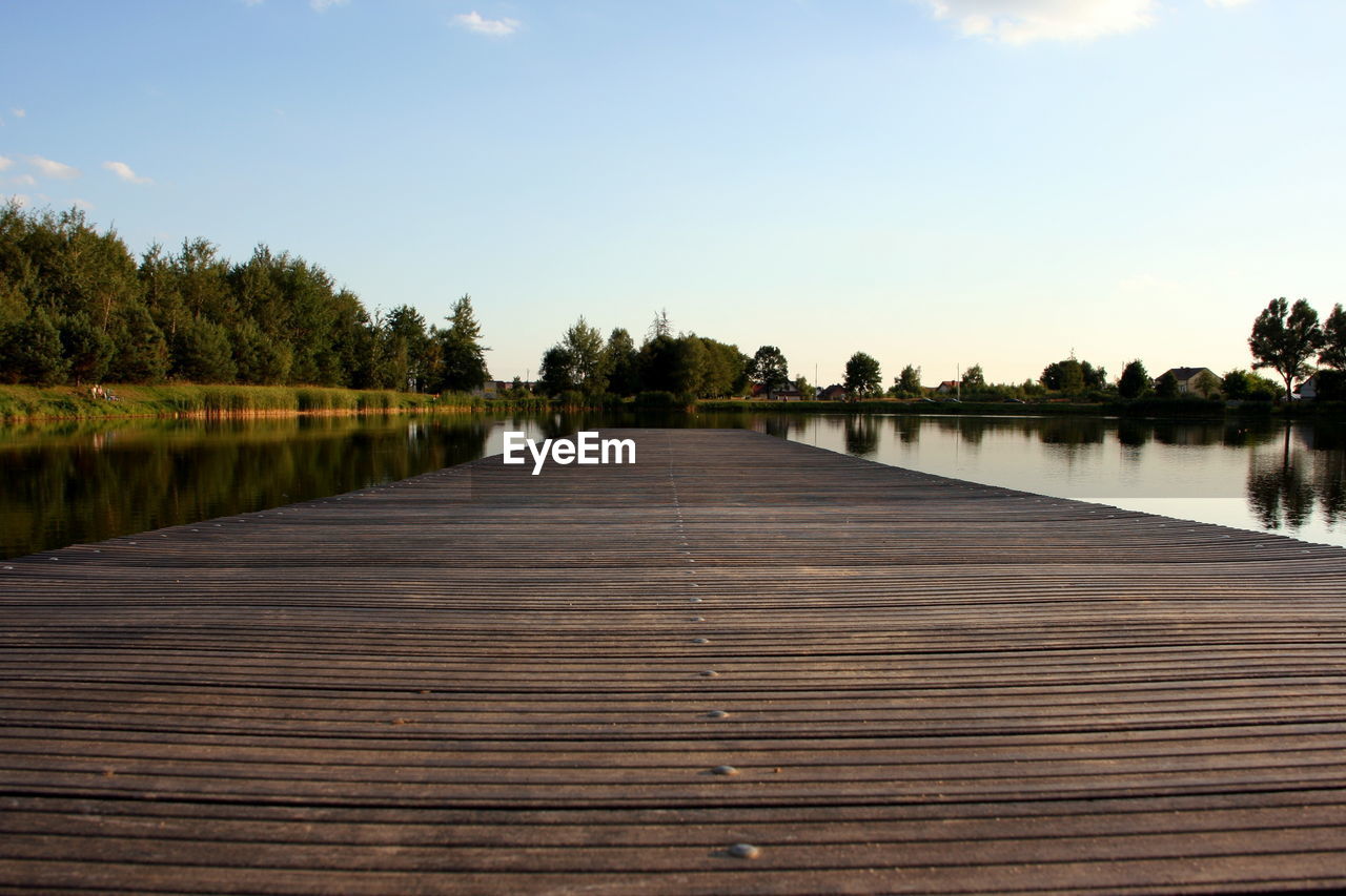 Pier over lake against sky