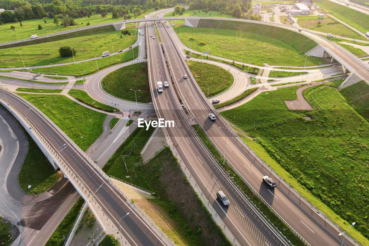 Cars moving on transport road junction in city, aerial view