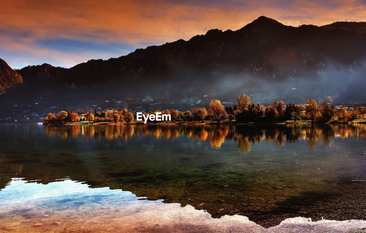 Scenic view of lake against sky during sunset