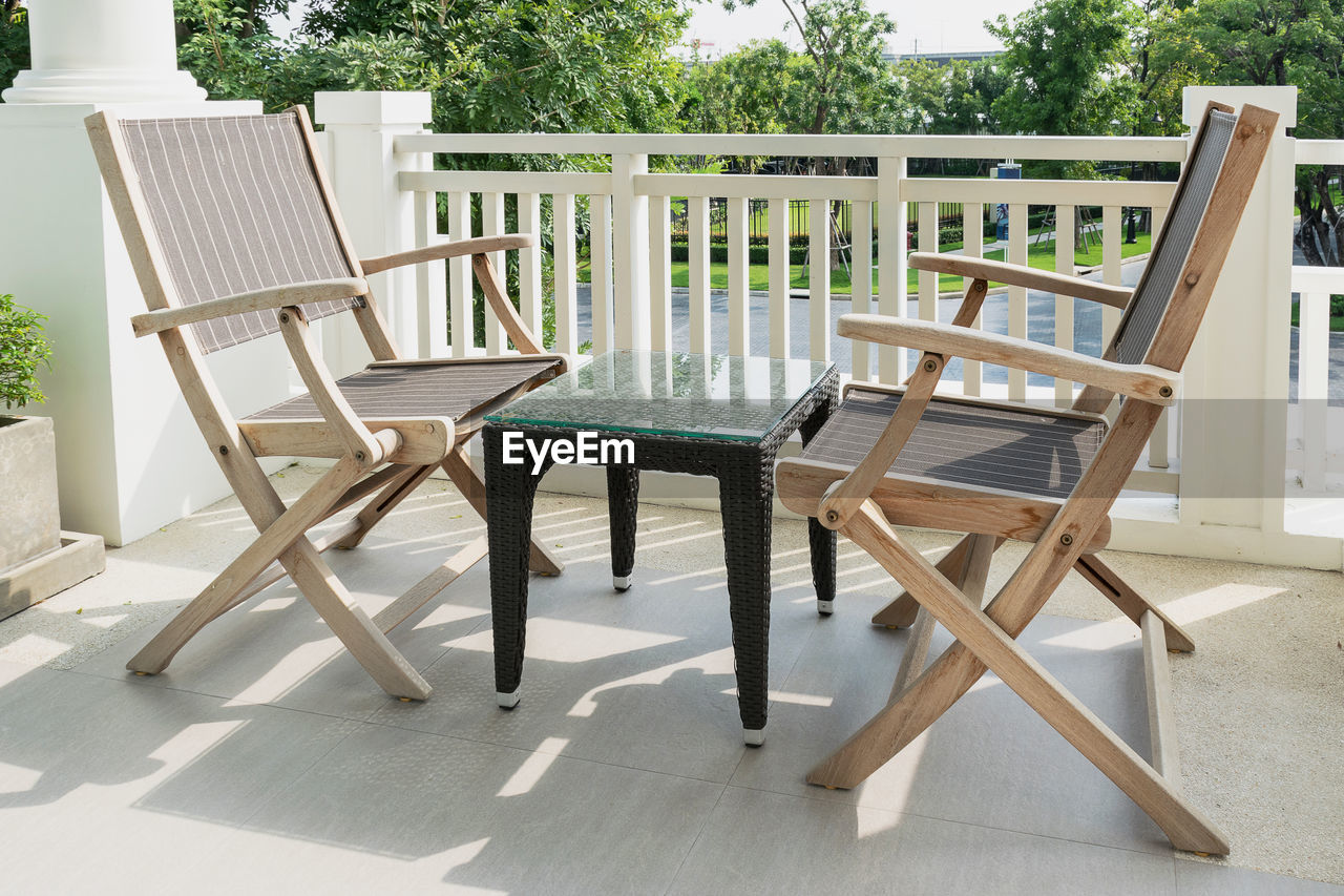 Empty chairs and tables at porch