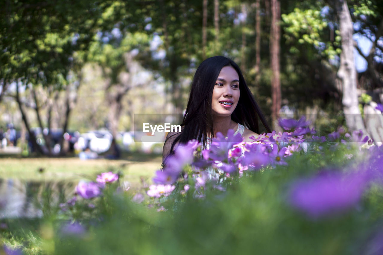 Woman standing on purple flowering plants