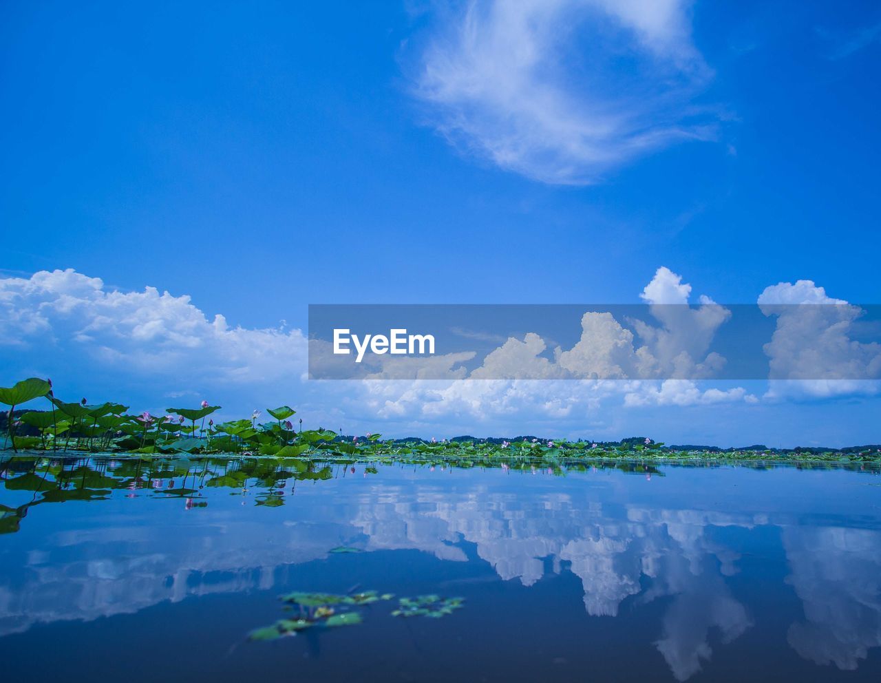 Scenic view of lake with clouds reflection