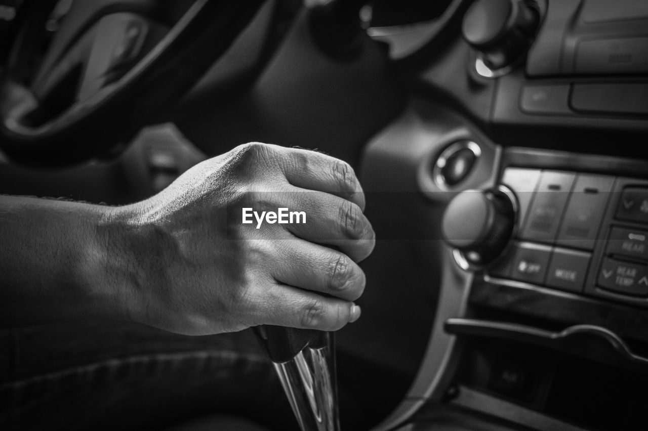 Cropped image of hand holding gearshift