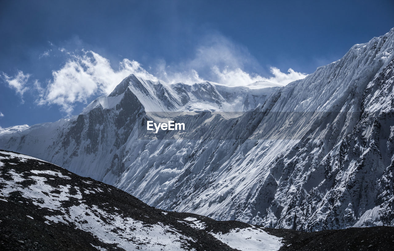 Scenic view of snowcapped mountains against sky