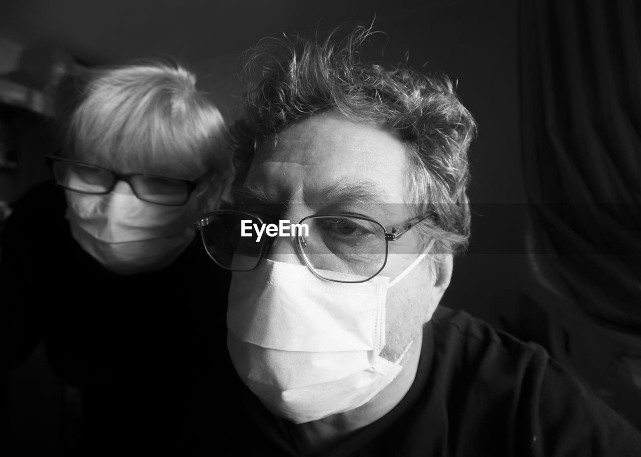 Close-up of man and woman wearing flu masks