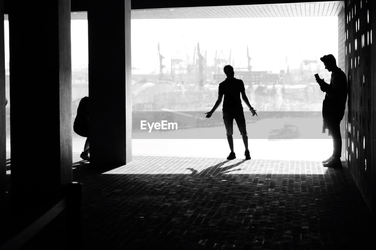 SILHOUETTE WOMAN STANDING ON CORRIDOR