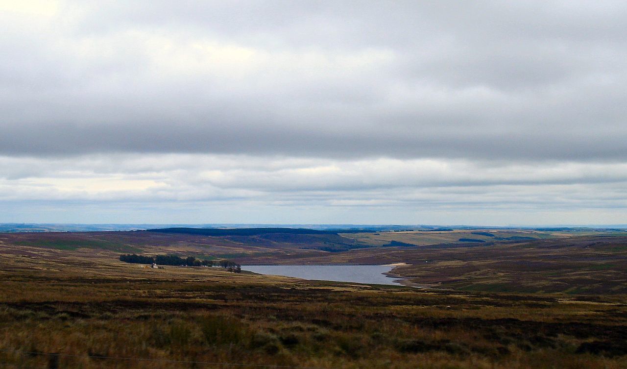 Scenic view of landscape against cloudy sky