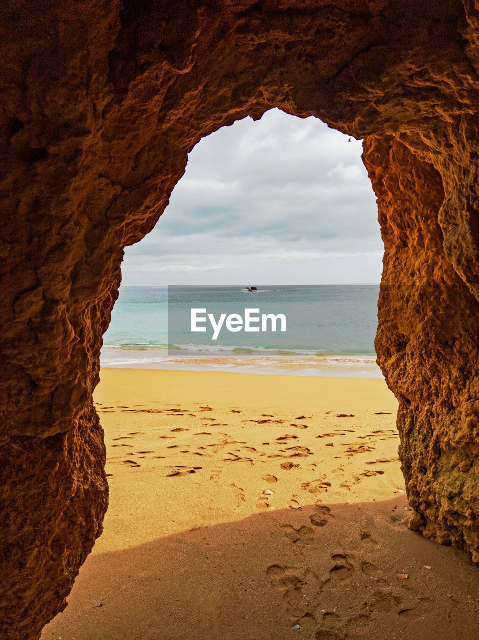 Scenic view of sea seen through cave