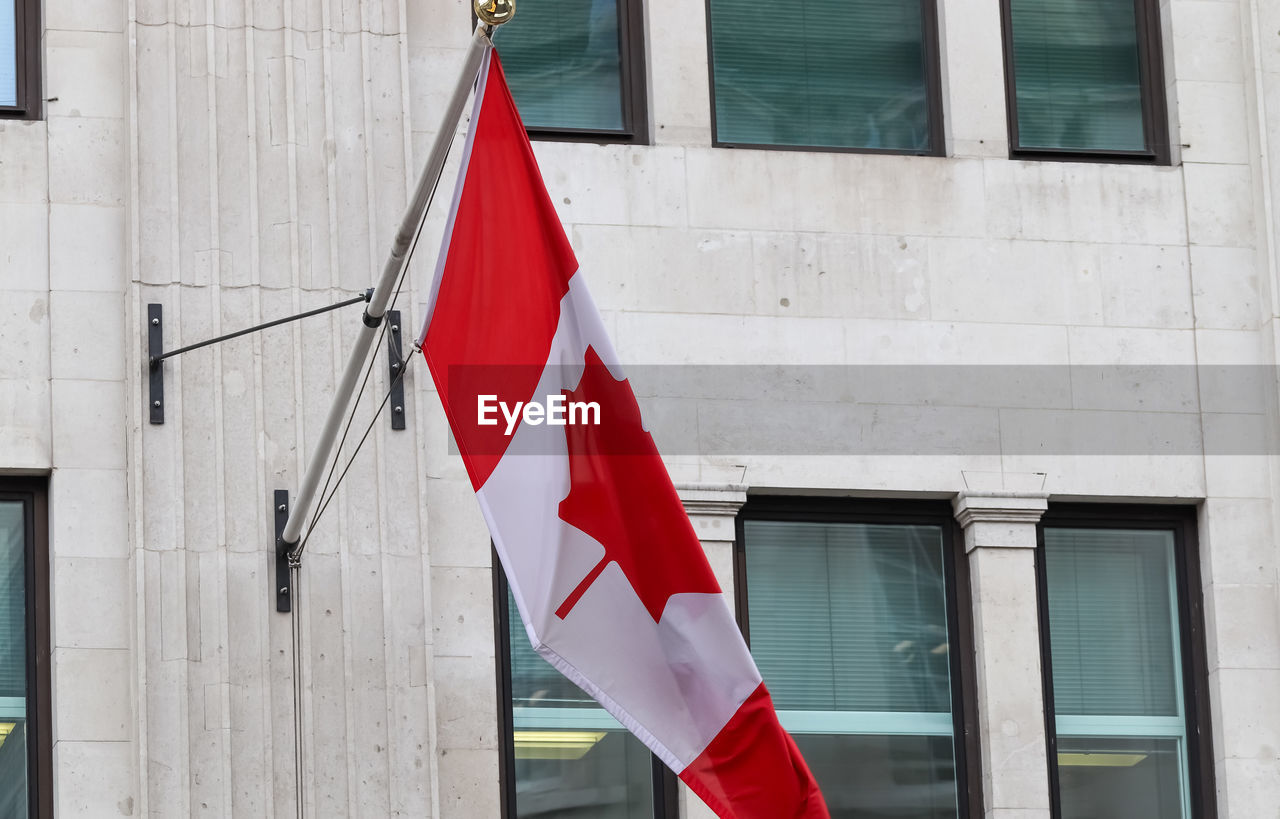 Canadian flag hanging on building