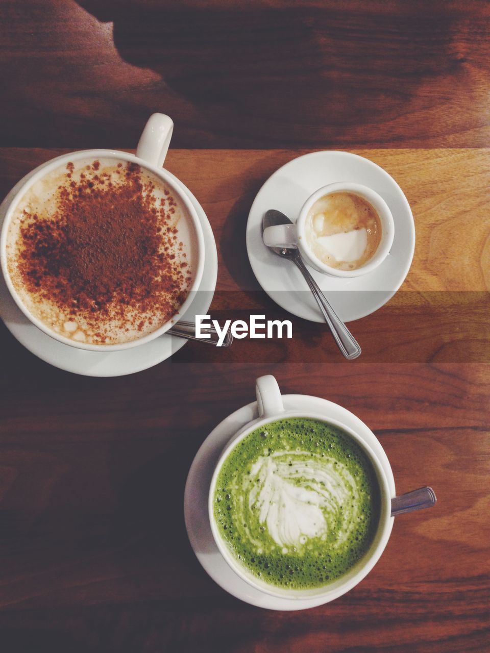 High angle view of fresh coffees served on table in cafe