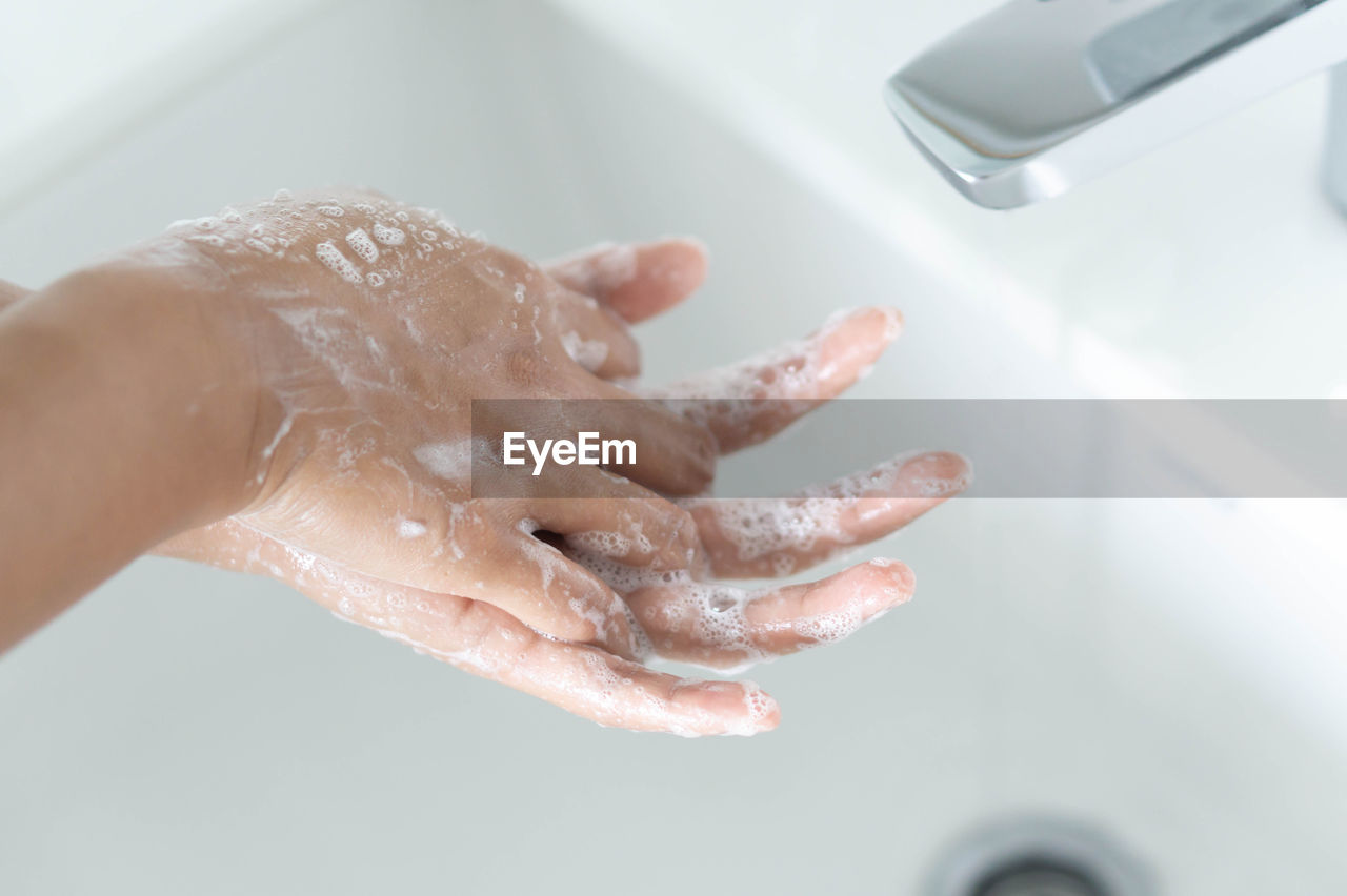 Woman washing hands in sink