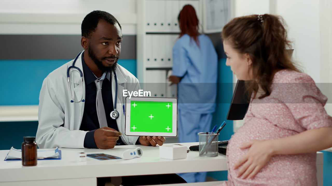 female doctor giving medicine to patient at clinic