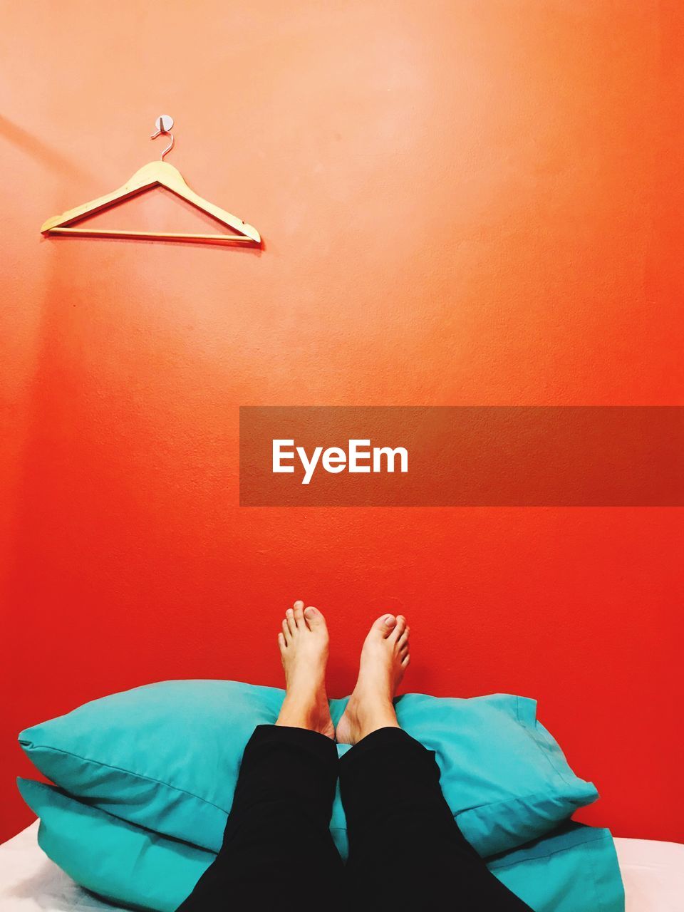 Low section of woman lying on bed