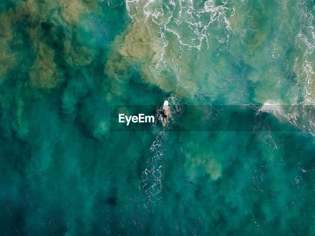 Aerial view of man surfing in sea