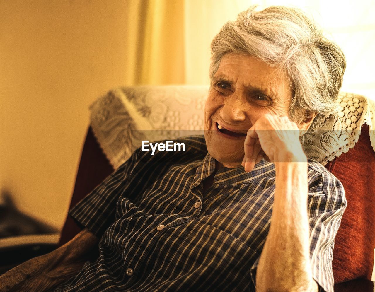 Happy senior woman sitting on chair