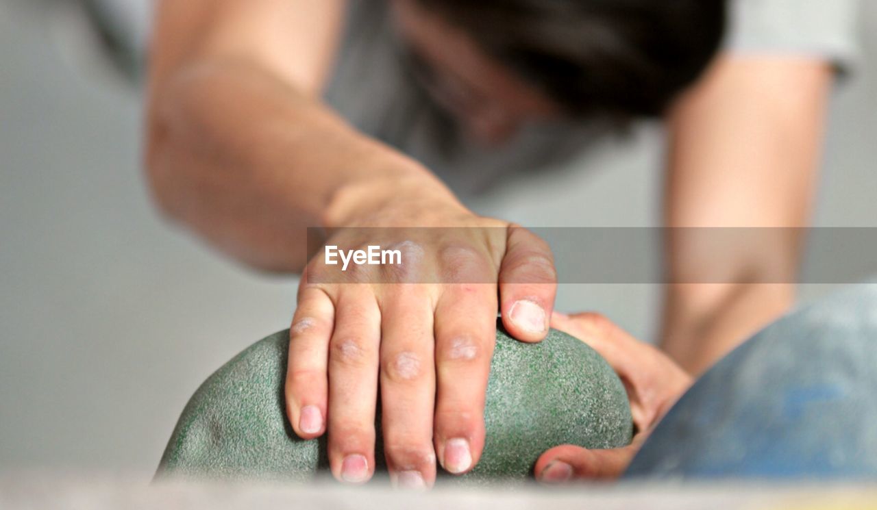 High angle view of boy climbing wall