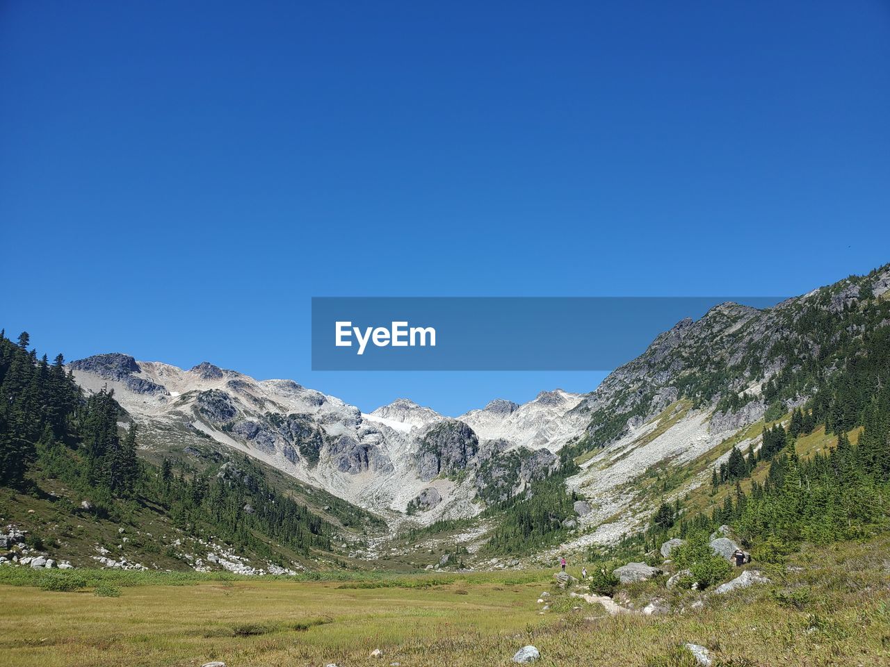 Scenic view of mountains against clear blue sky