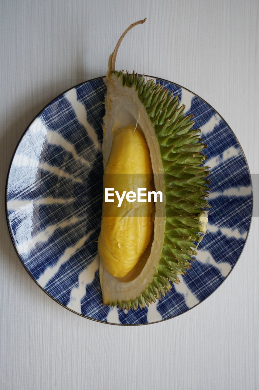 food, food and drink, healthy eating, wellbeing, fruit, freshness, indoors, produce, plant, studio shot, no people, directly above, yellow, still life, plate, slice, close-up, high angle view, vegetable, table, cross section