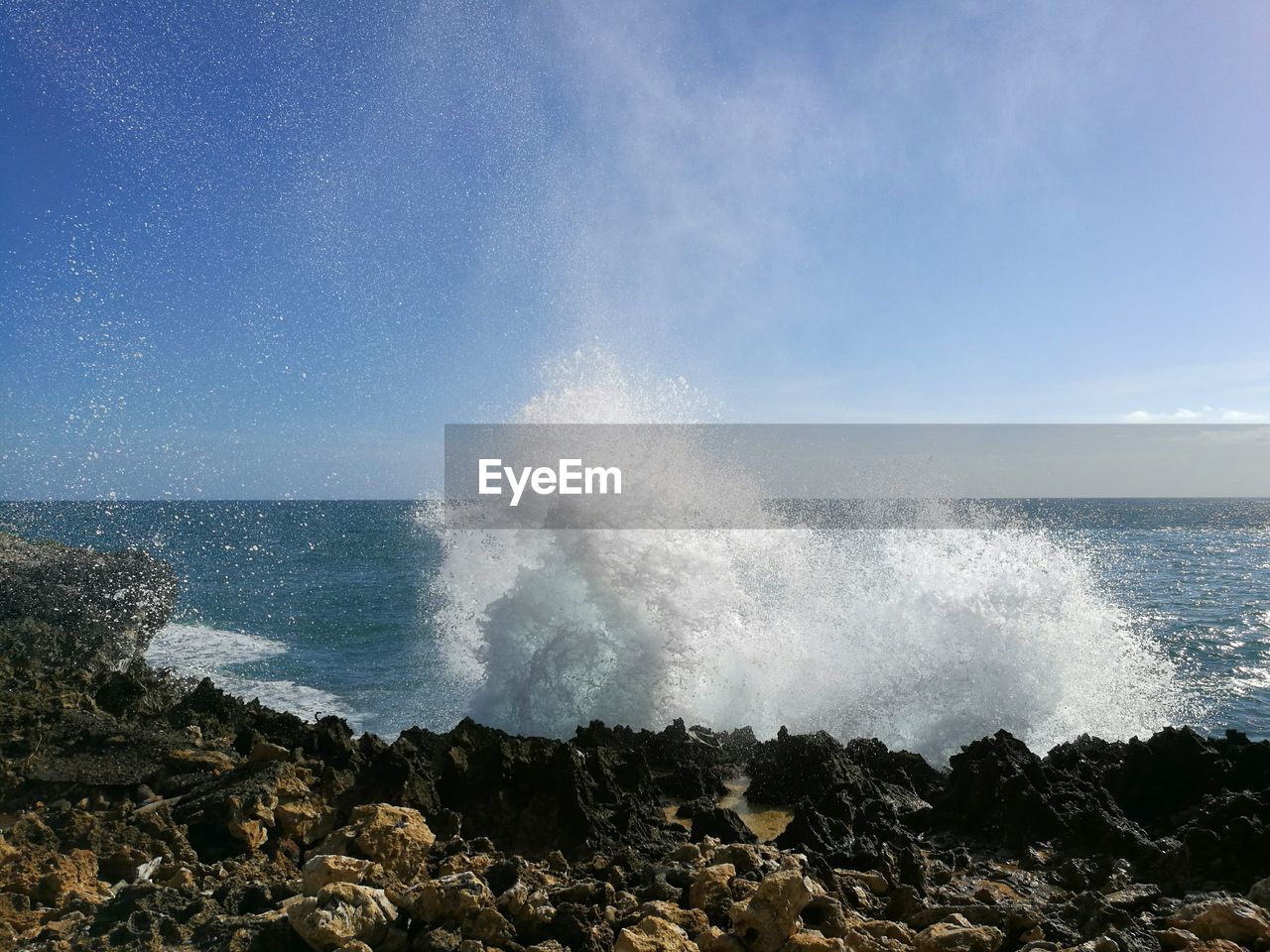 WAVES SPLASHING ON ROCKS AGAINST SEA