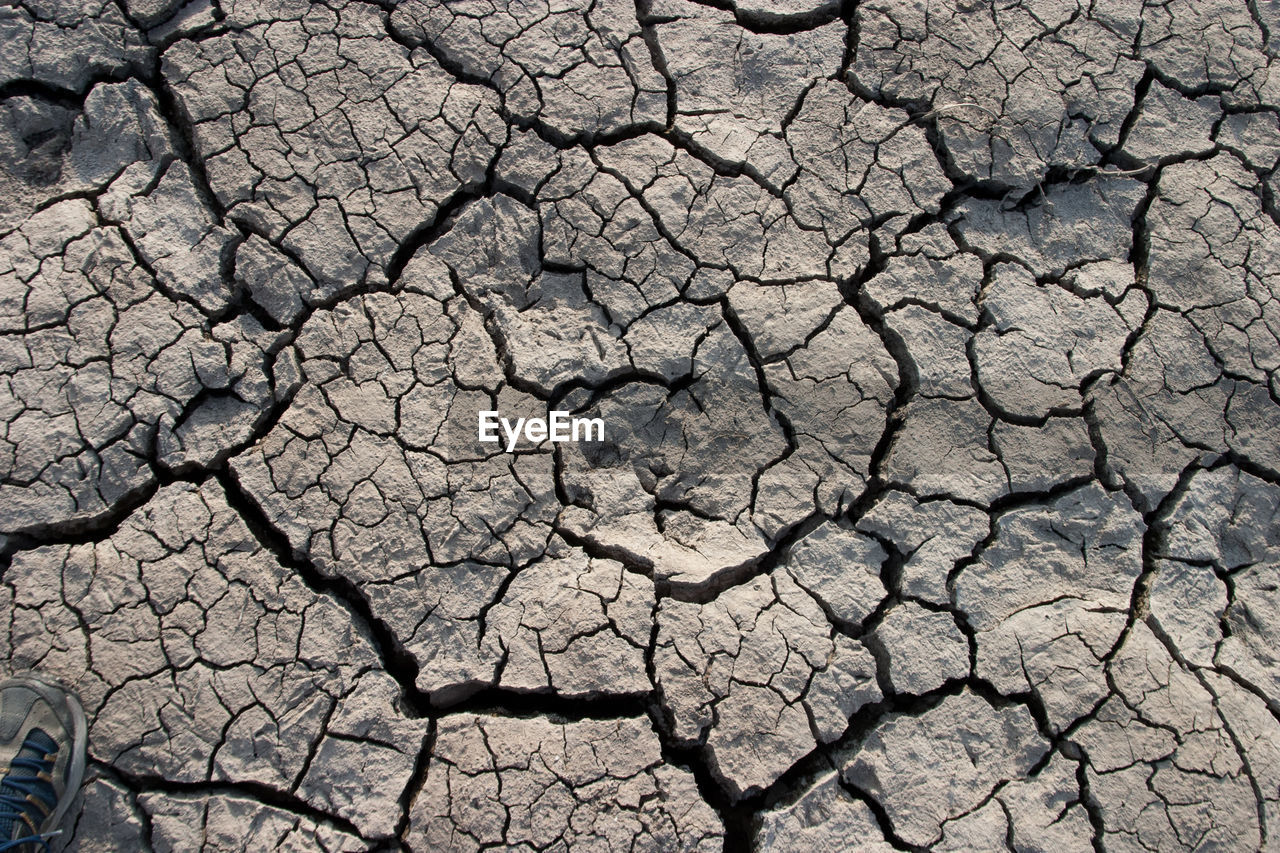 High angle view of cracked field