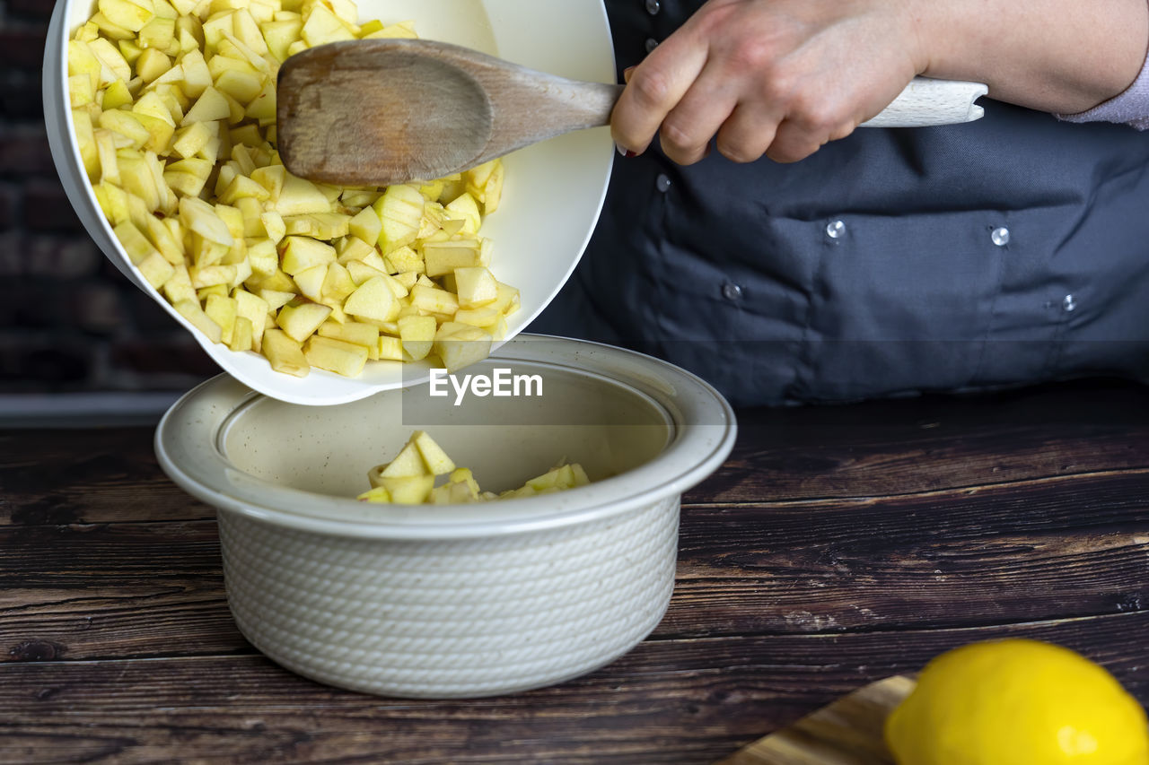 Women preparing delicious apple tart or pie .apples in small pieces