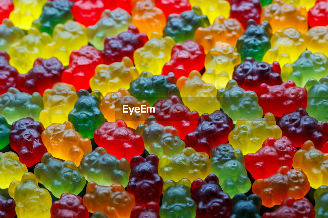 Closeup full-frame background of colorful jelly bears laid closely on a flat surface