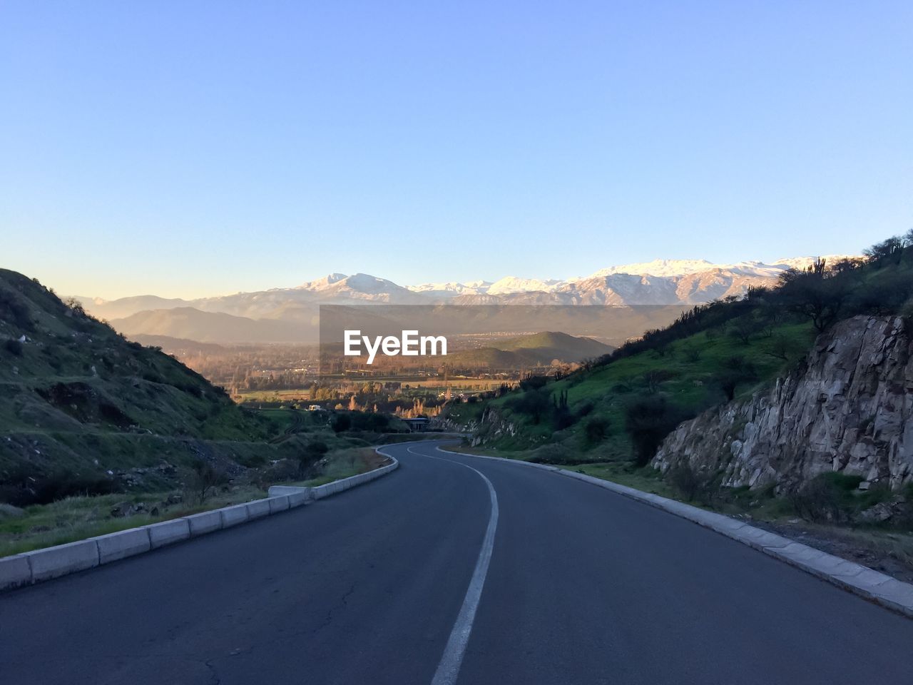 ROAD BY MOUNTAIN AGAINST CLEAR SKY