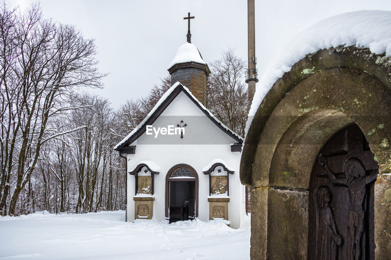 CHURCH BY BUILDING DURING WINTER