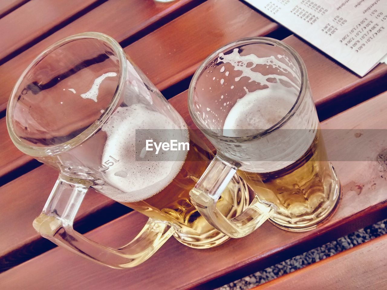 CLOSE-UP HIGH ANGLE VIEW OF BEER GLASS ON TABLE