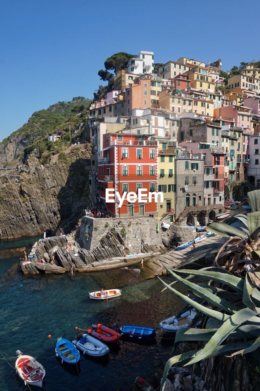 Buildings at manarola against clear blue sky