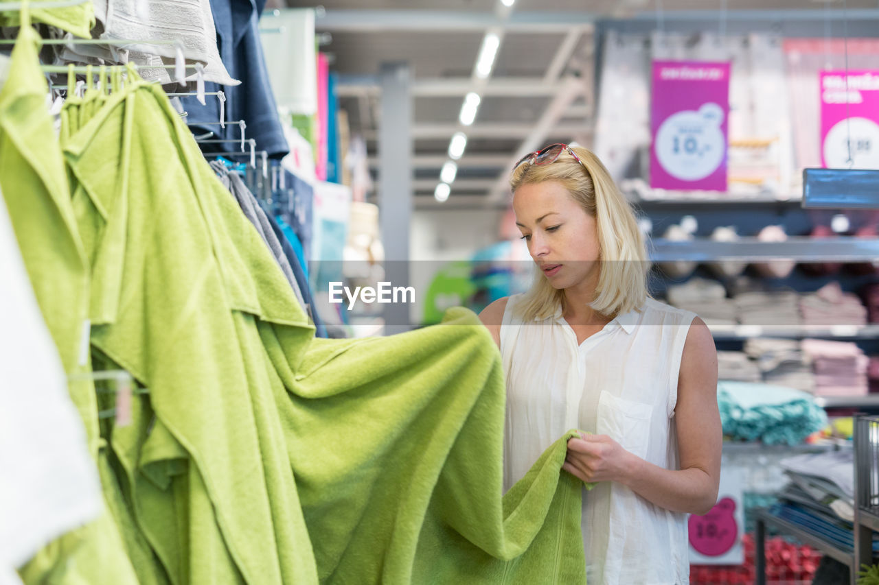 Mid adult woman standing at departmental store