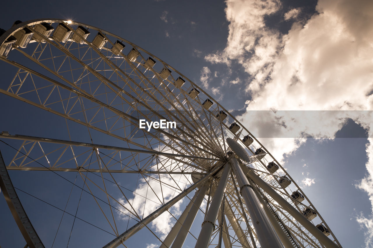 Low angle view of ferris wheel against sky