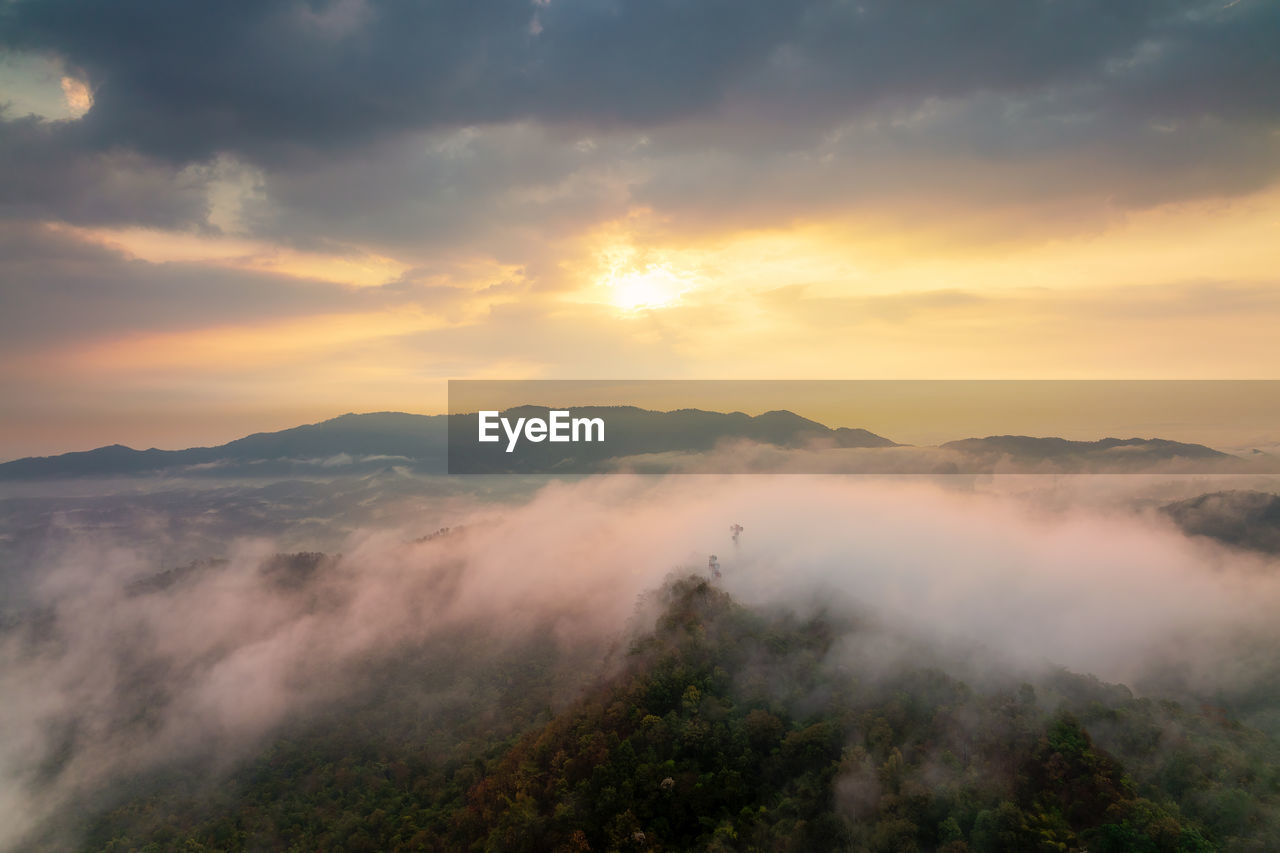 Beautiful fog in the morning forest with green mountains. pang puai, mae moh, lampang, thailand.