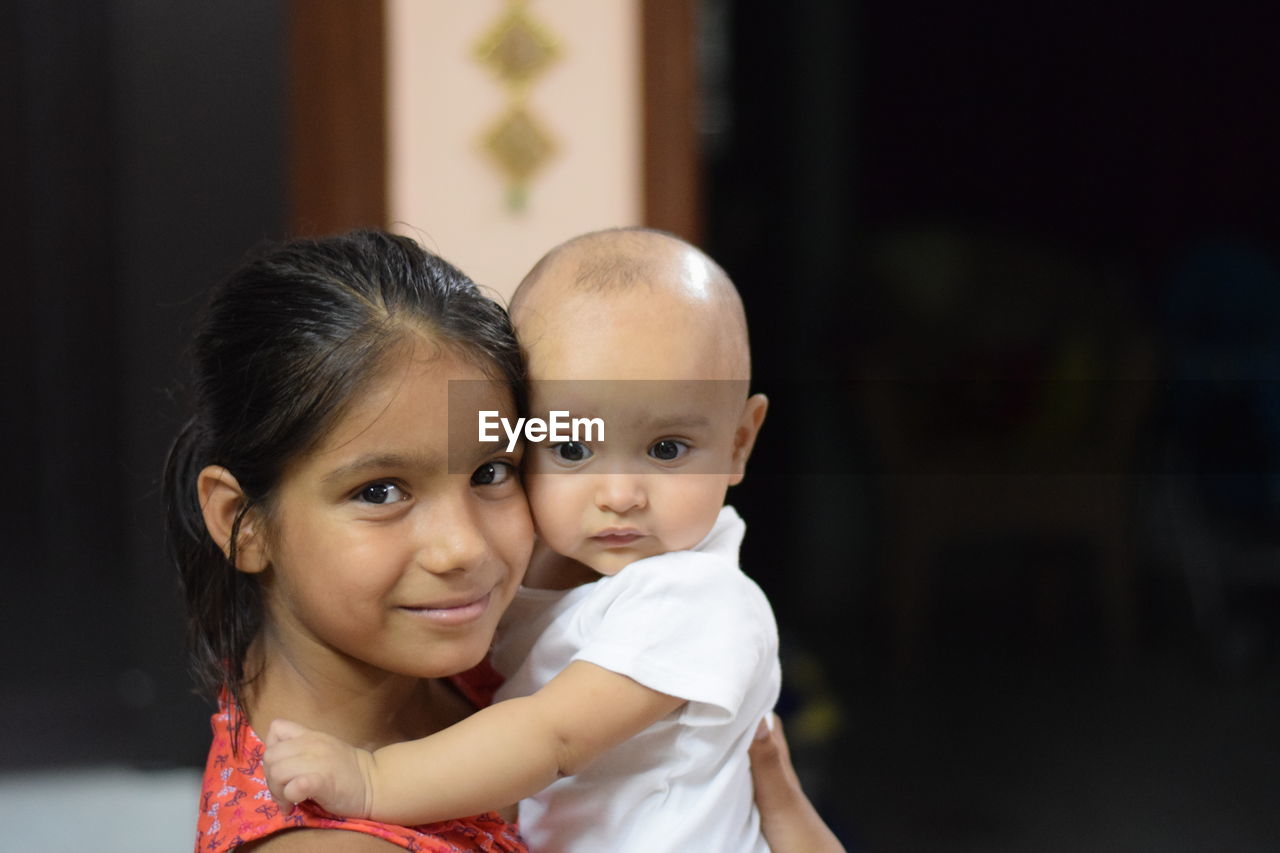 child, childhood, two people, women, female, togetherness, family, portrait, person, baby, emotion, love, positive emotion, adult, smiling, looking at camera, happiness, parent, bonding, portrait photography, cute, embracing, innocence, indoors, one parent, care, toddler, human face, affectionate, lifestyles, cheerful, clothing, focus on foreground, ceremony, holding, headshot, men, copy space