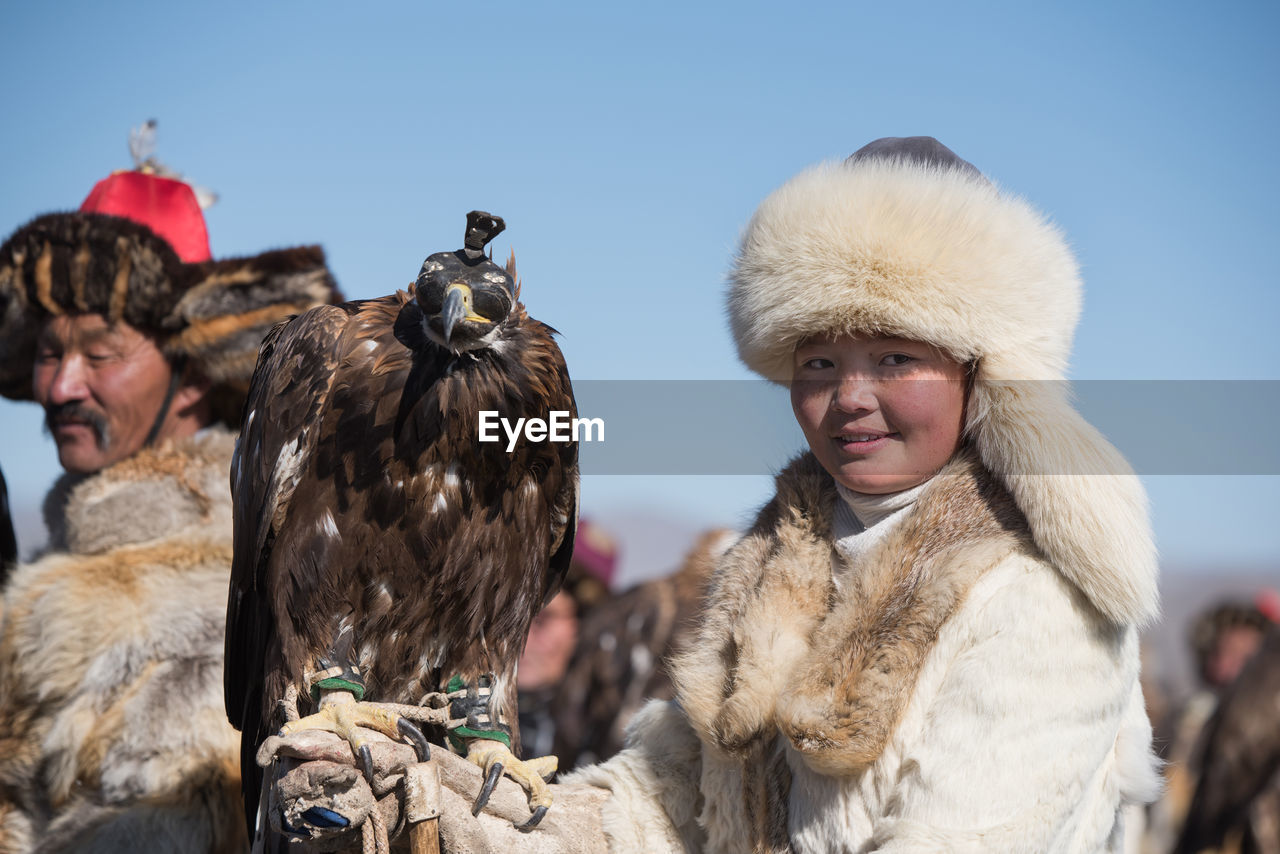 PORTRAIT OF WOMAN AND BIRDS IN WINTER